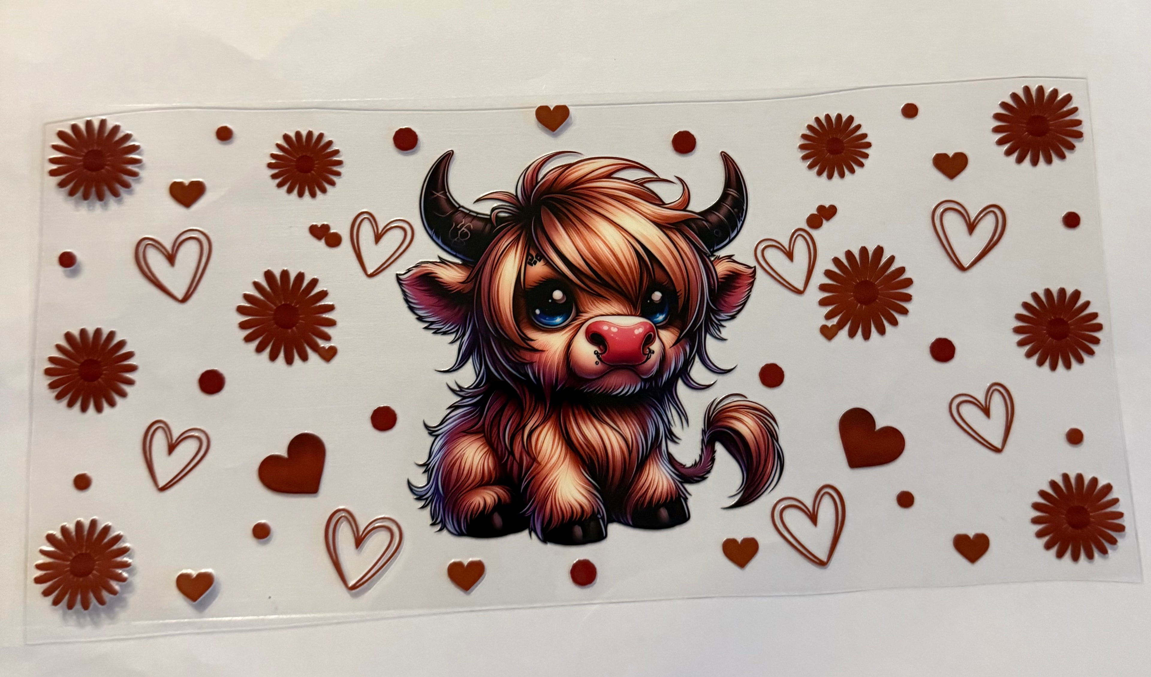 Cow with brown hearts and flowers