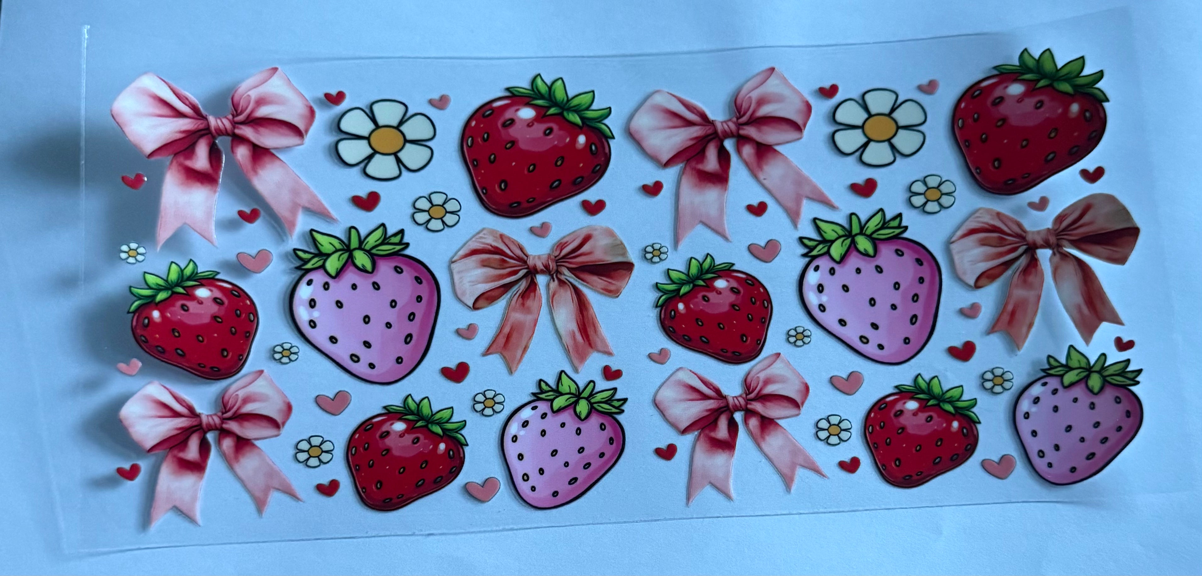 Red and pink strawberries with bows