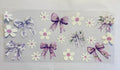 Purple and white bows with flowers
