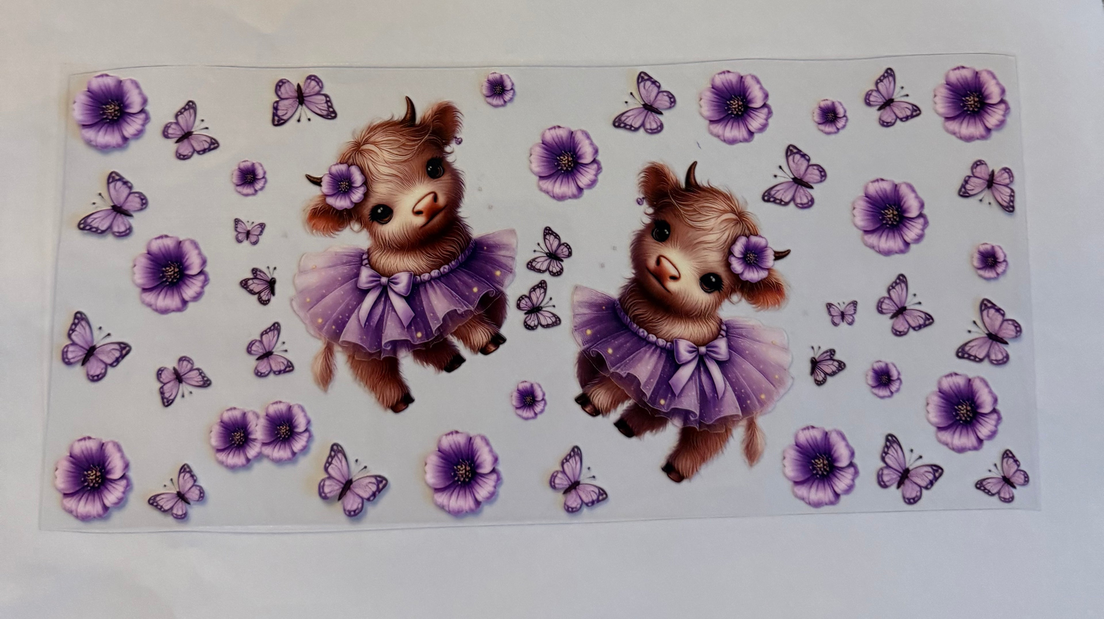 Cow in purple tutu with butterflies and flowers