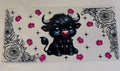 Black cow and flowers