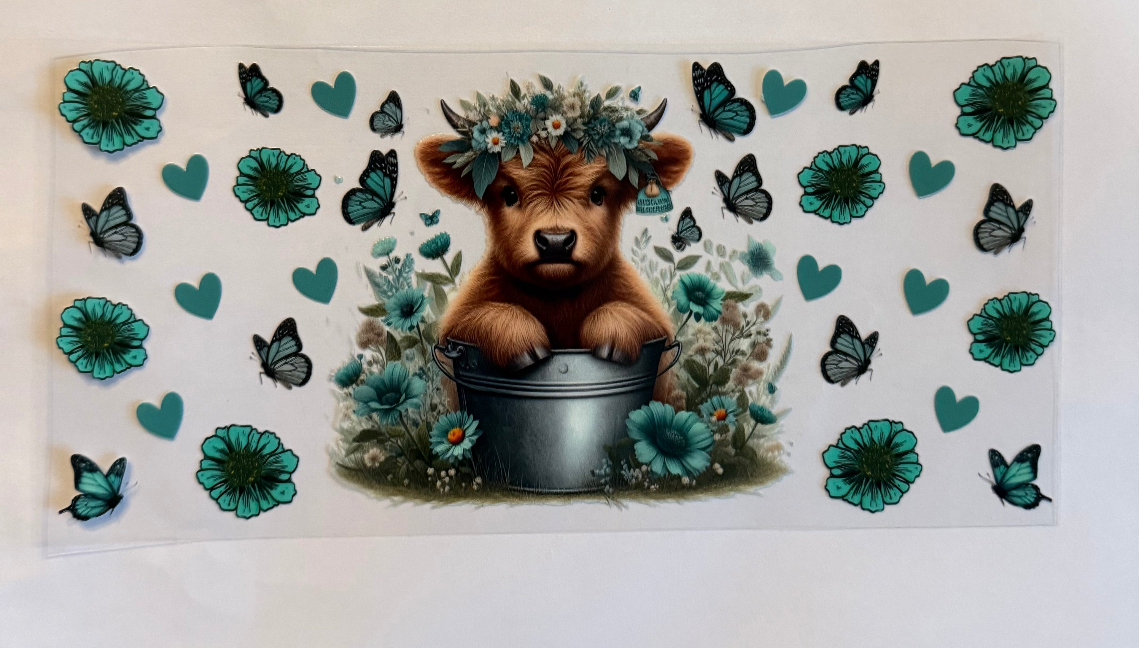 Cow in bucket with flowers and butterflies