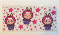 Brown Labubu with pink stars